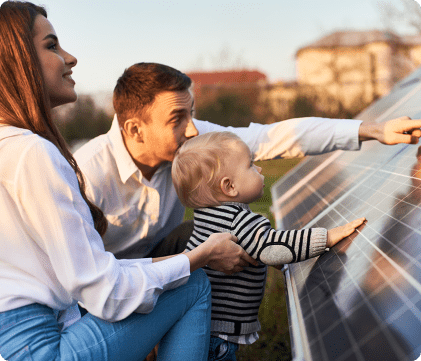a couple and child touching a solar panel