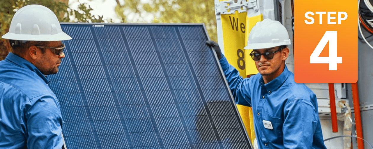 Two installers with hardhats about to begin a residential solar panel installation